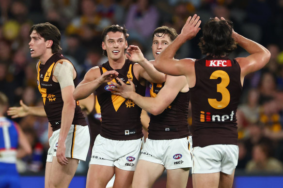 Hawthorn celebrate a goal.