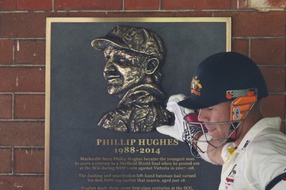 David Warner touches a tribute to Phillip Hughes at the SCG in 2015.