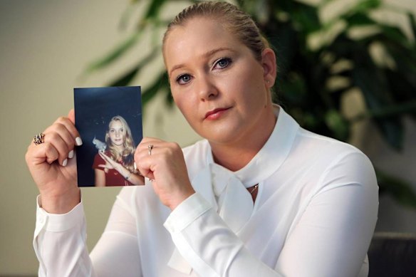 Virginia Giuffre, with a photo of herself as a teen, when she said she was abused by Jeffrey Epstein, Ghislaine Maxwell and Prince Andrew, among others.