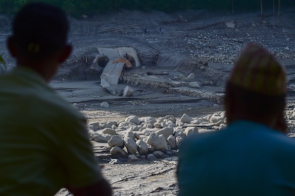 Residents look at a damaged tunnel of the Trishuli hydropower plant on Sunday.