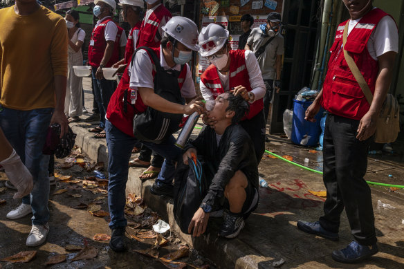 Medics supply oxygen to protesters who were exposed to tear-gas during clashes with the military and police in Yangon on Wednesday.