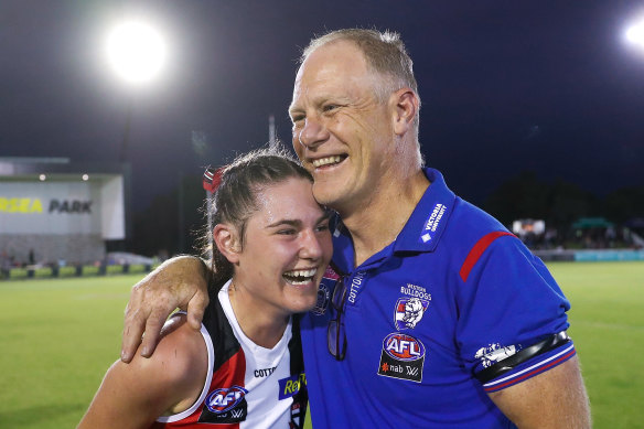 Alice, playing with the Saints where her father Nathan used to play, embraces her dad after a game.