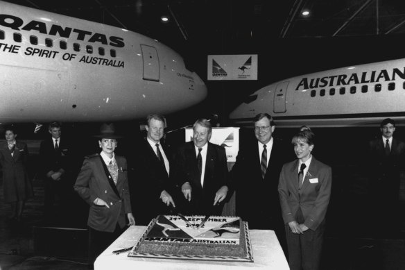 The official merger of Qantas and Australian Airlines is celebrated with champagne and cake at Mascot. The integrated company will have combined fleet of 120 aircraft. September 14, 1992.