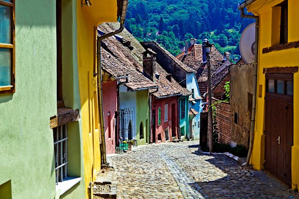 Brightly coloured homes open to cobblestoned alleys that wind through Sighisoara.