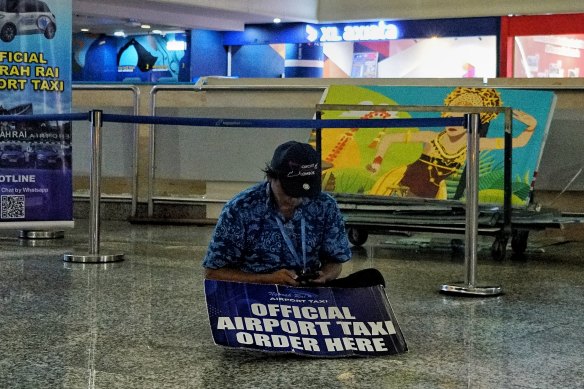 Made, a Bali taxi driver, waiting in the empty international arrivals hall close to midnight on Wednesday.