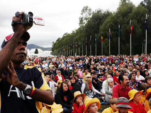 Thousands of people watch TV screens on the Parliament lawns as Australian Prime Minister Kevin Rudd delivers an apology to the Aboriginal people for injustices committed over two centuries of white settlement, February 13, 2008.