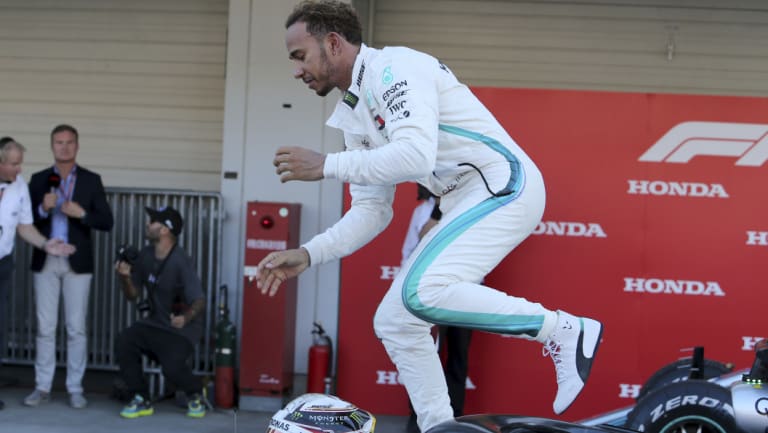 Counting down: Hamilton, jumping off his Mercedes during celebrations, could win the title in Austin.