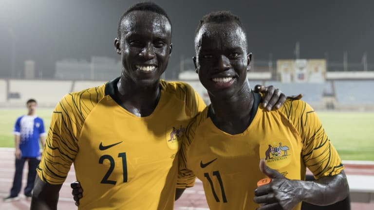The world game: Thomas Deng and Awer Mabil, childhood friends who bonded as kids in Adelaide after coming to Australia from South Sudan, after their debuts for the Socceroos.