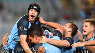 Bolt from the Blues: Matt Burton (left) celebrates with NSW teammates in July.