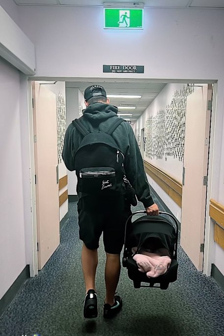 Joey Manu leaves hospital with his newborn daughter.