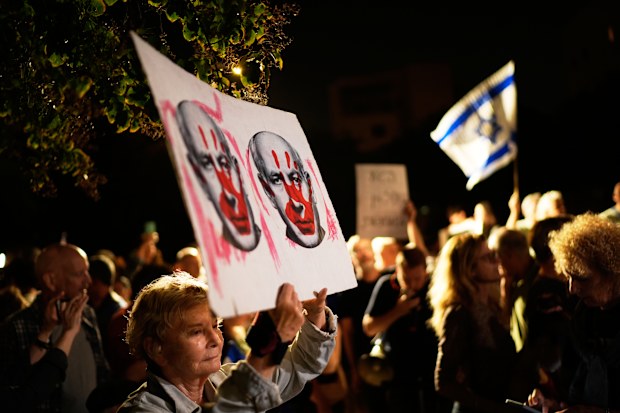 Israeli left-wing activists call for a government with Arab parties outside Yashar party leader Gadi Eisenkot’s residence in Herzliya, Israel.