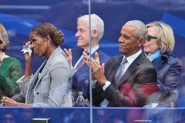 Former President Barack Obama claps on stage during the dedication ceremony for the Obama Presidential Centere