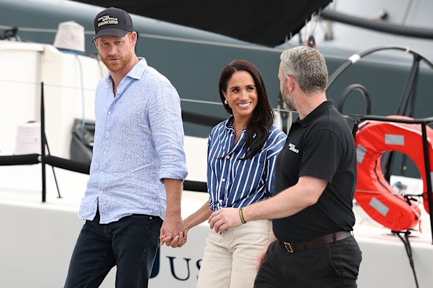 SYDNEY, AUSTRALIA - APRIL 17: Prince Harry, Duke of Sussex and Meghan, Duchess of Sussex speak with Michael Hartung, Chief Executive Officer of Invictus Australia at the Cruising Yacht Club of Australia on April 17, 2026 in Sydney, Australia. The Duke and Duchess of Sussex are on a four-day visit to Australia, with engagements across Melbourne, Canberra and Sydney. (Photo by Cameron Spencer/Getty Images)