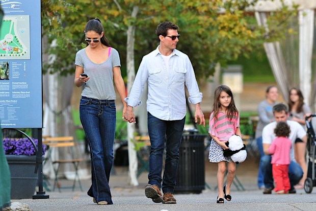 Tom Cruise, Katie Holmes and Suri Cruise walk together on October 8, 2011.