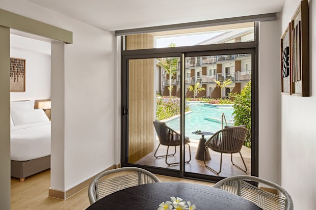 Hotel room looking out onto a pool