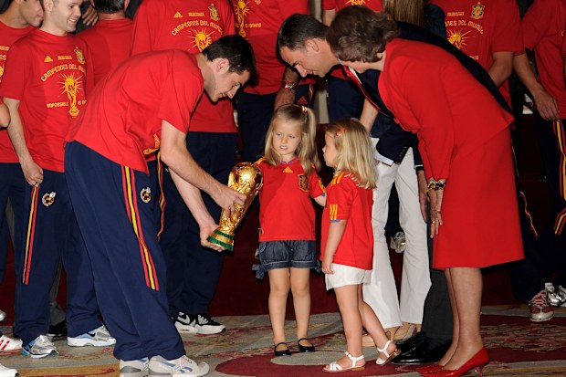 Princess Leonor and Princess Sofia are shown the trophy by goalkeeper and captain Iker Casillas, watched by Prince Felipe and Queen Sofia of Spain while the FIFA 2010 World Cup winning team Spain are received by the Spanish royal family at Zarzuela Palace on July 12, 2010 in Madrid, Spain.