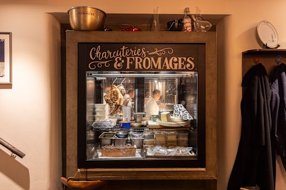 The cheese and charcuterie cabinet greets diners upon descending the stairs to the subterranean restaurant.