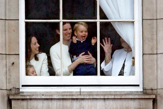 Prince George looks through a window in Buckingham Palace prior to the Trooping The Colour ceremony on June 13, 2015 in London, England.