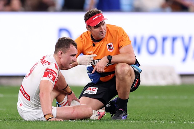 Liddle speaks with a trainer after going down with a leg concern