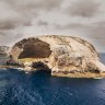 Where will you find the island, also known as Skull Rock?