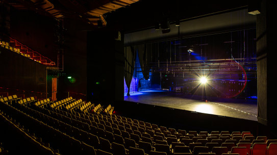 A 'ghost light' keeps vigil at an empty Hamer Hall while the Arts Centre remains closed.