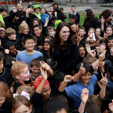 The prime minister surrounded by adoring fans in an Auckland schoolyard.
