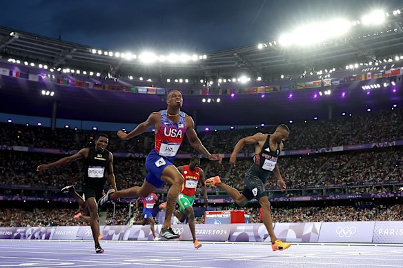 Quincy Hall of  United States crosses the finish line to win the gold medal ahead of silver medallist Matthew Hudson-Smith of Great Britain and bronze medallist Muzala Samukonga of  Zambia during the men’s 400m final. 