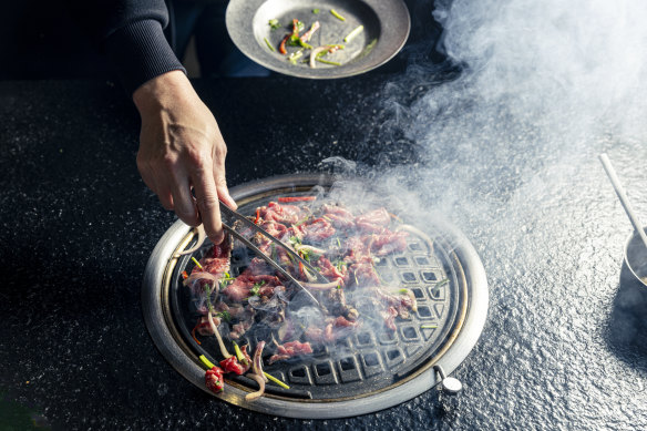 Cooking the beef on the grill.