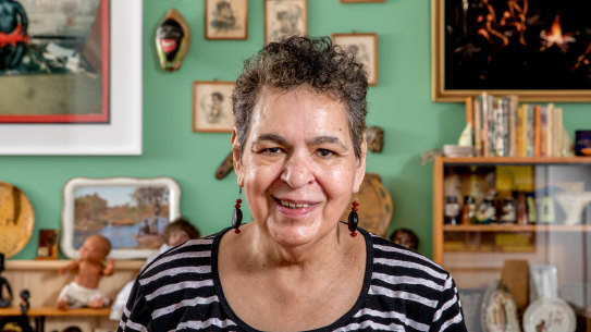 Destiny Deacon inside the NGV exhibition, with some of the ''Koorie kitsch'' she has collection over the years. 