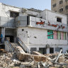 Palestinians ride bicycles past Al Basma IVF Centre, Gaza’s largest fertility clinic.