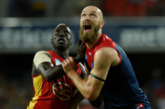 Gold Coast's Mabior Chol tests himself against the best, Melbourne captain Max Gawn.