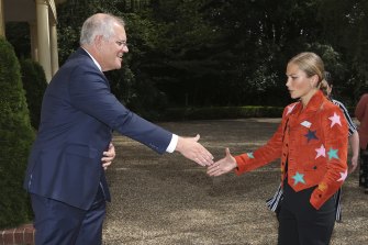 Prime Minister Scott Morrison greets 2021 Australian of the Year Grace Tame at the Lodge in Canberra on Tuesday.