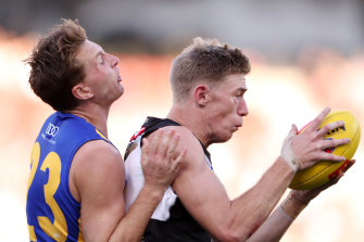 Todd Marshall of the Power marks the ball from Alex Witherden of the Eagles. 