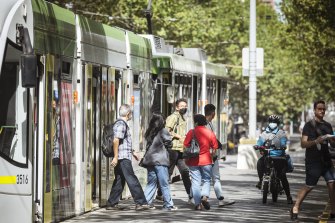 A tram on Swanston Street on Sunday. Epidemiologist Catherine Bennett says wearing a well-fitted mask on public transport is a great “equaliser”.