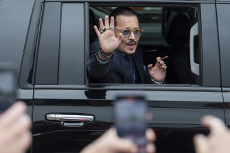On a typical day of the trial: Johnny Depp waves to supporters as he departs Fairfax County Courthouse on May 27.