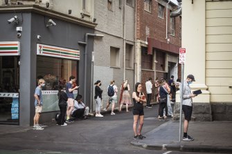 People queue outside the Prahran Town Hall COVID-19 testing clinic in Melbourne. There is high demand for PCR tests as case numbers rise.