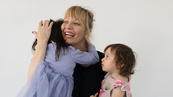 Katie with her daughters, May, 3 and Yianna, 1, will not change where she shops for her Easter eggs this year in Sydney, but is bracing for the Easter shop to be more expensive. 