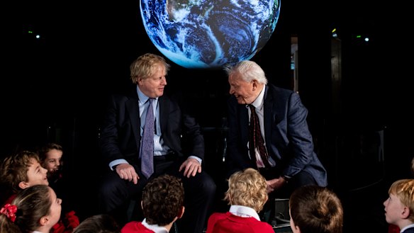 British Prime Minister Boris Johnson and British broadcaster and naturalist Sir David Attenborough speak with schoolchildren during the launch of the UK-hosted COP26 UN Climate Summit in Glasgow.