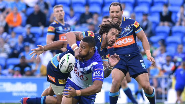 Letting loose: Ofahiki Ogden gets away an offload under pressure from Kevin Proctor at CBUS Super Stadium.