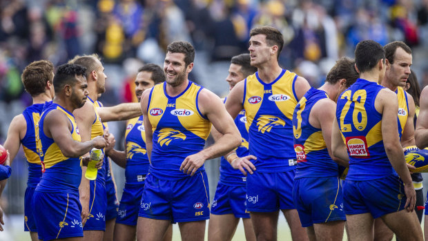 Kicking on: The Eagles celebrate claiming their 13th win of the season, after victory over the Western Bulldogs at Optus Stadium in Perth.