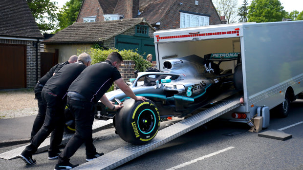 Members of the Mercedes team delivering the Formula One replica.