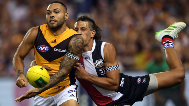 Tight contest: Hawthorn's Jarman Impey (left) gives off under pressure from Saint Ben Long.