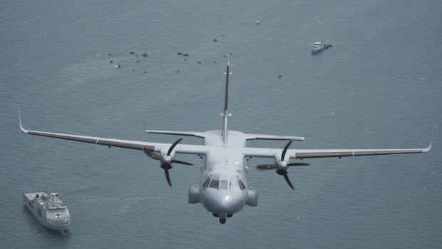 An Indonesian Navy plane surveys the wreckage of the crashed Sriwijaya Air passenger jet in the Java Sea.