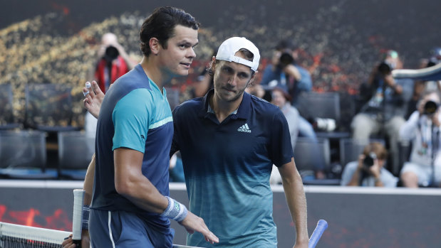 Lucas Pouille (right) is congratulated by Milos Raonic after the match.