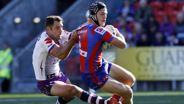 Come here, young fella: Cameron Smith hangs on to Kalyn Ponga in the win over Newcastle.