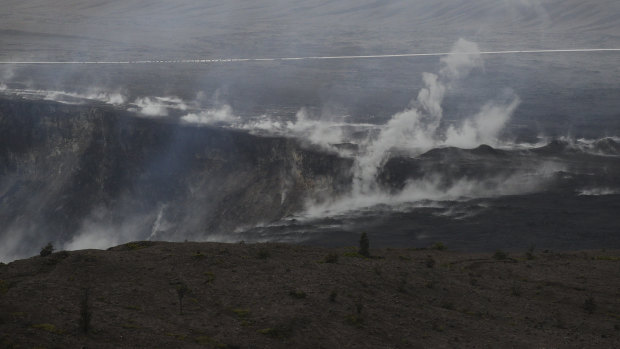 Steam and gas rise along the edge of Kilauea's summit crater.