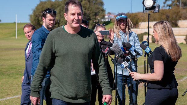 Ross Lyon departs his media conference after being sacked by Fremantle.