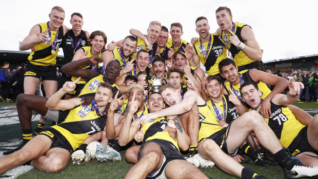 Craig McRae, top left, helps Richmond celebrate their 2019 VFL grand final win, of which he was coach. 