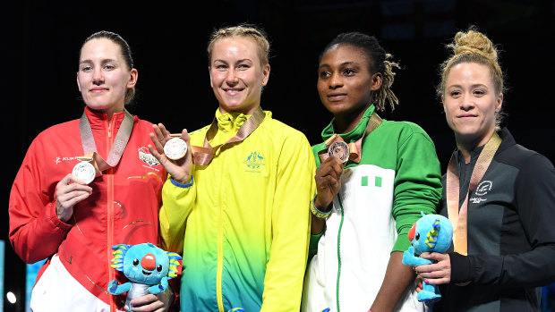 Paige Murray of England, Anja Stridsman of Australia, Yetunde Odunuga of Nigeria and Troy Garton of New Zealand during the medal ceremony.