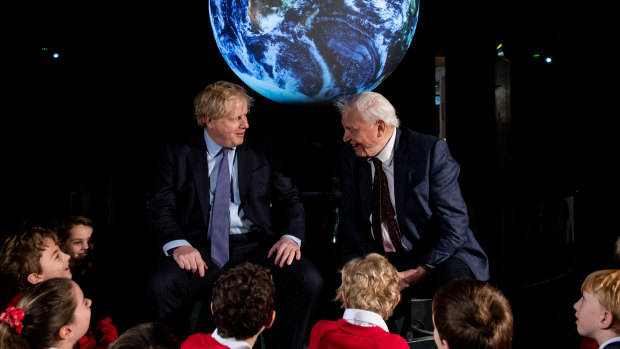 British Prime Minister Boris Johnson and British broadcaster and naturalist Sir David Attenborough speak with schoolchildren during the launch of the UK-hosted COP26 UN Climate Summit in Glasgow.